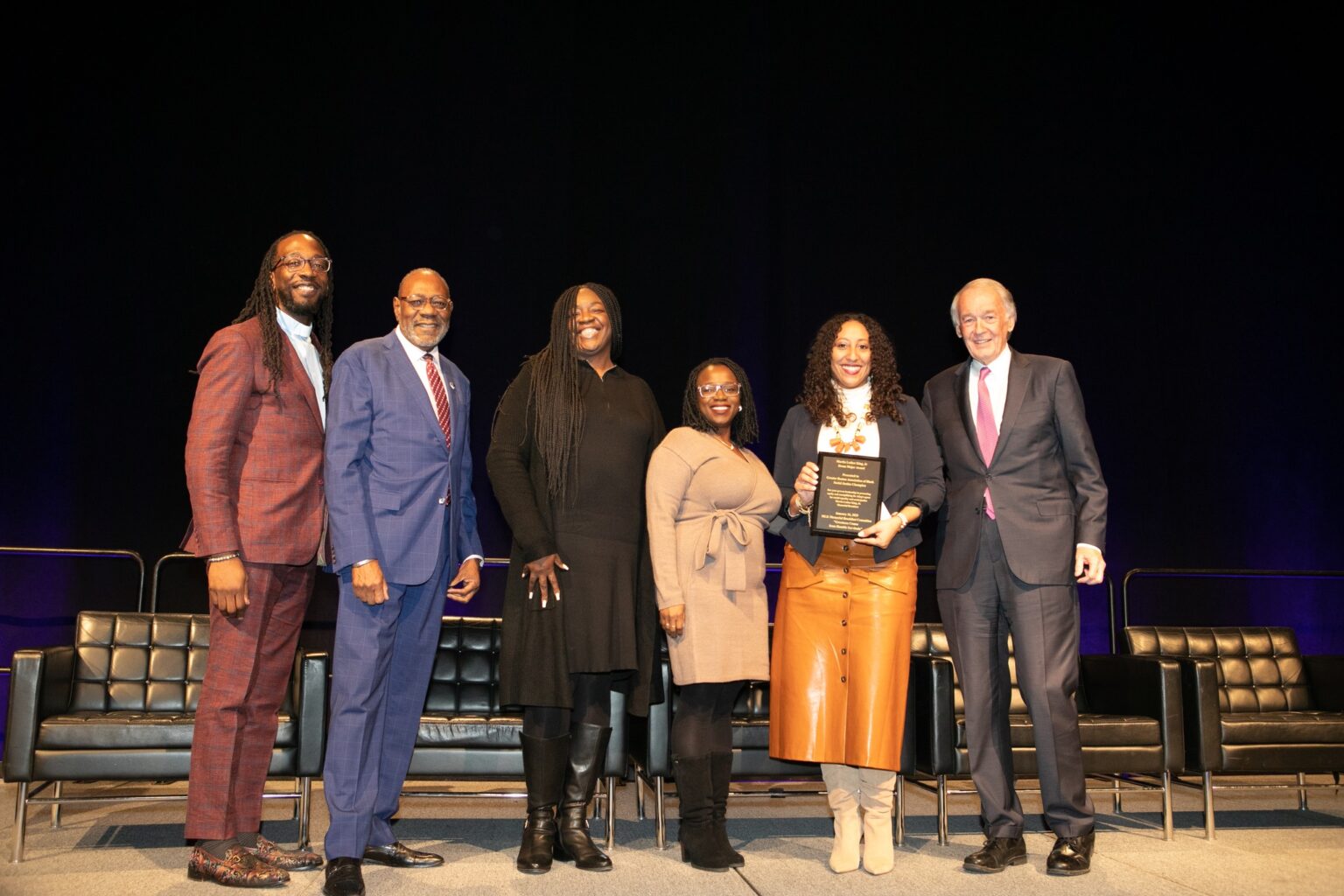 Kathy Lopes, representing Greater Boston Association for Black Social Workers, Inc., accepts the 2023 Drum Major Award with Sen. Ed Markey and MLK Memorial Breakfast Committee Co-Chairs Rev. Dr. Jay Williams and James Dilday, Esq.